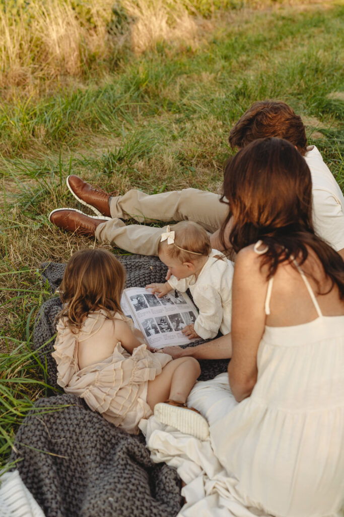 Family of four reading a book together in Indiana 